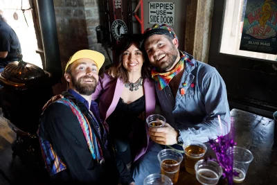 Three friends sharing drinks at the bar.