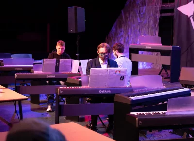 Three piano students are the first to play a mini concert for the day.