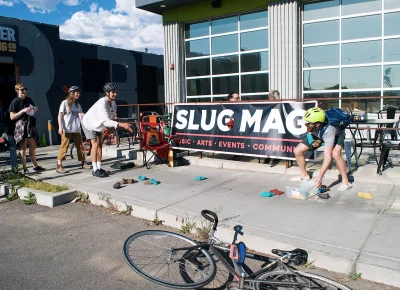 SLUG Cat participants throwing bean bags into a basket.