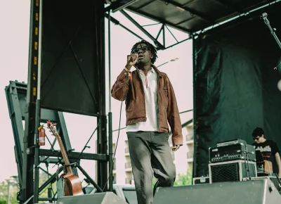 Performer with microphone on stage at Kilby Block Party 3