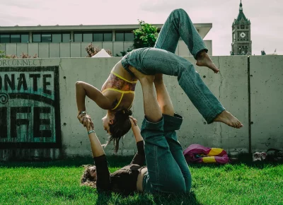 Two girls doing couples yoga at Kilby Block Party