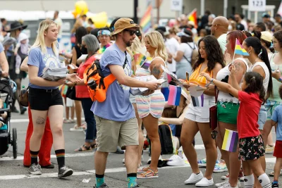 (L–R): Audrey Lockie and Steven Goemaat handing out SLUG Magazines along the Utah Pride Parade route.