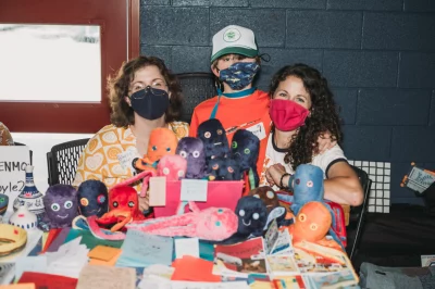 (L–R) Bonne K.V. Cooper, Logan Braegger and Robyn Braegger with their zine Country Sister, City Sister.