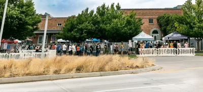 A line of people circling halfway around the block at Brewstillery 2022