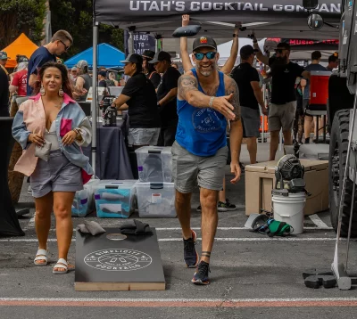 Two attendees enjoying a shot at prizes at a game of cornhole.