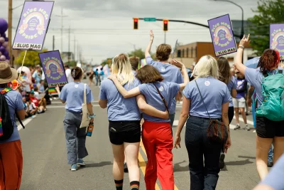 A pair of SLUG teamsters embrace near the end of the parade.