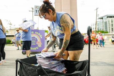 Stacking up papers to hand out to the thousands of people along the route.