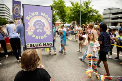 Young supporters of Pride see other young supporters participating in the Pride Parade.