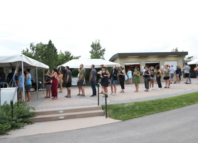 Guests taking a look at the merch table before the show gets started at Red Butte Garden Amphitheatre. (Photo: LmSorenson.net)