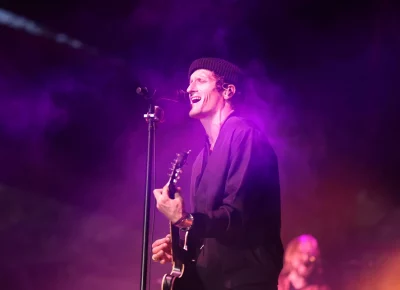 David Shaw of the Revivalists singing in a purple haze as the sun retreats for the evening. (Photo: LmSorenson.net)