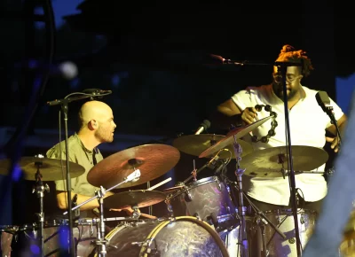 The Revivalist drummer and tambourine player playing live music.