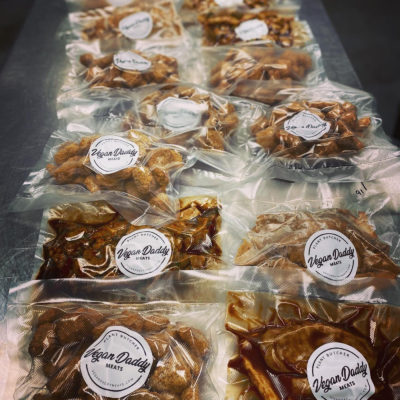 White tiles will line the walls of the plant-based butcher shop where you can see the “meat” being cut with a traditional meat slicer and wrapped in brown paper by the pound.