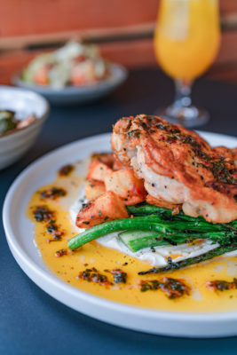 The Roasted Chicken has a generous portion of crispy, bone-in chicken flavored with Za’atar seasoning rested on top of potatoes and grilled broccolini with diced cucumber, whipped feta cheese and a drizzle of chermoula, a chimichurri-esque relish.