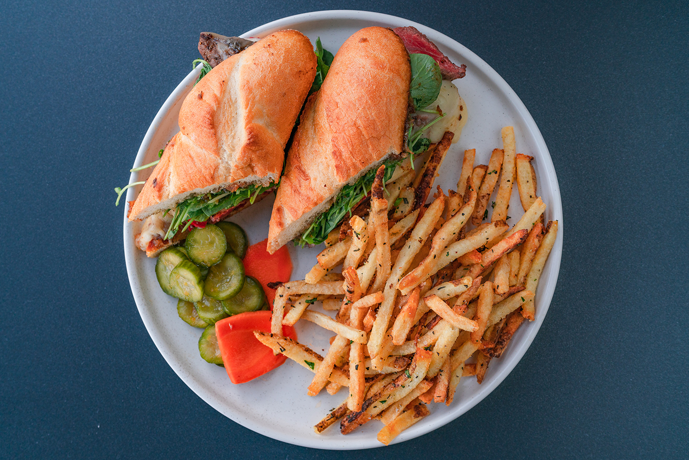 The Wagyu Steak Sandwich at Franklin Ave. is served on toasted bread with au poivre, Taleggio cheese, Calabrian chiles, bacon-date jam and fresh watercress.