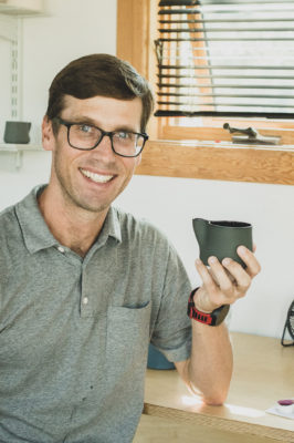 Matt Sutton displays his clean, intricately 3D printed ceramic mug from his home goods collection, available for purchase on his website.