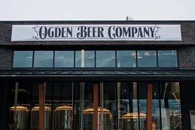 The exterior of Ogden Beer Company features windows showing the brewing equipment inside. Photo: Lexi Kiedaisch