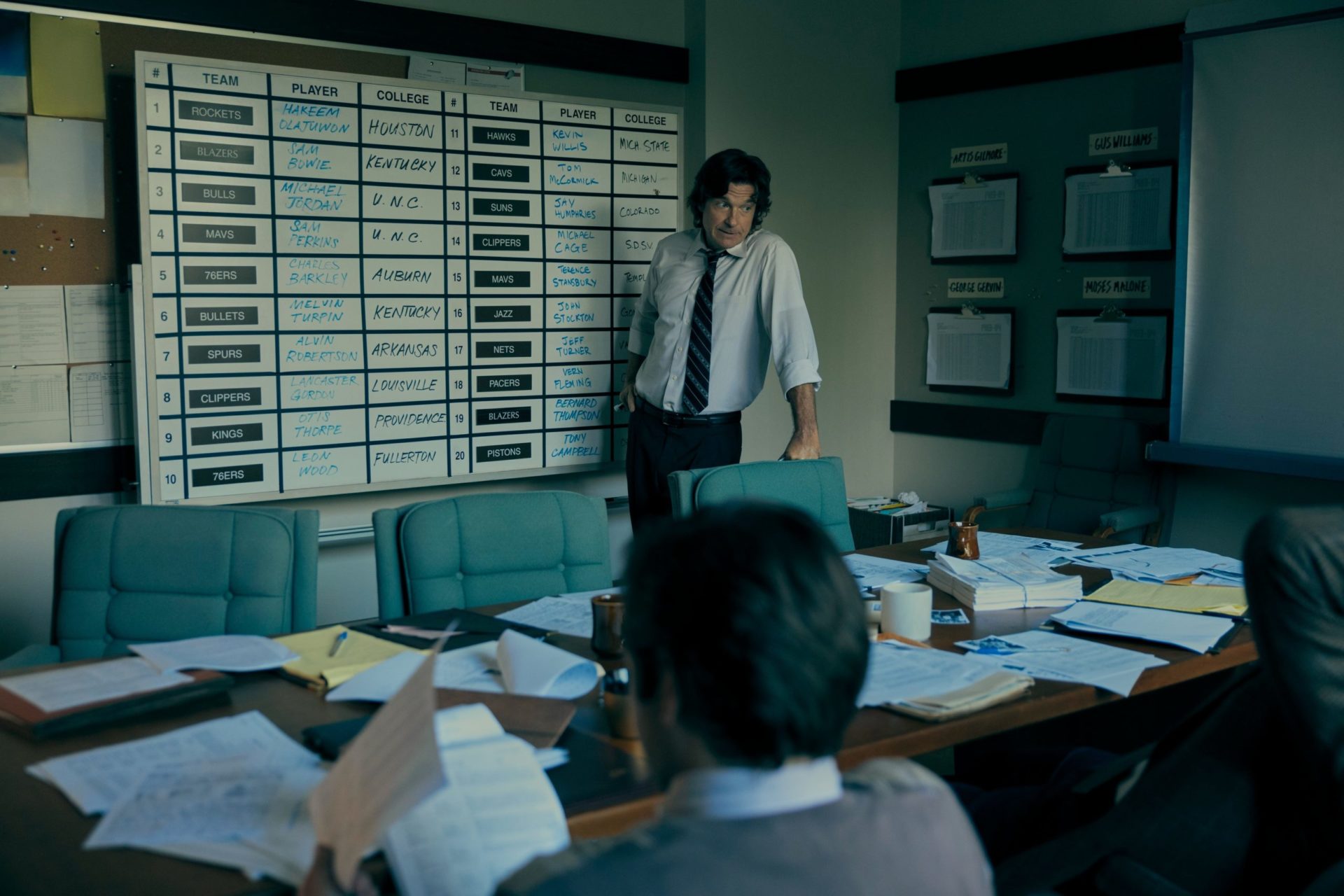 Two men stand in a dimly lit office. Photo courtesy of Amazon Studios.