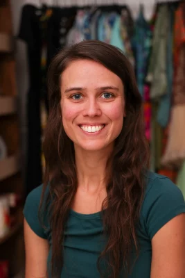 Headshot of Michelle Sharer smiling at the camera in a dark green shirt.