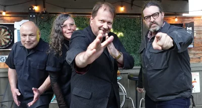 All dressed in black, Jeff and Robin Kilpatrick, Jon Bean and Ryan Workman pose for the camera at Handle Bar.