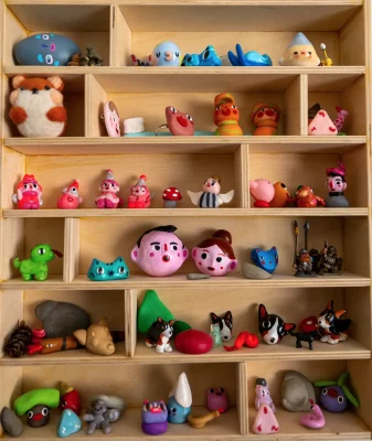 A cabinet holding Barney's figurine artwork.