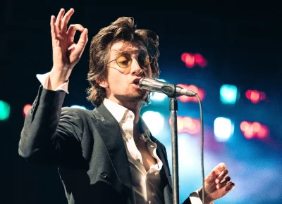 Lead singer of Arctic Monkeys performing vocals for the band's performance at the Delta Center.