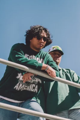 Bobby B Mac and Vehnu Moon lean over a ledge.