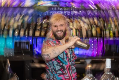 Photo of Tyler Fernberg making a cocktail. 