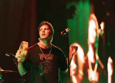 Grian Chatten holds a tambourine.