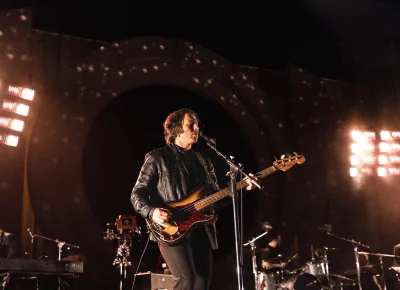 Nick O'Malley playing guitar for the Arctic Monkeys.