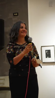 Winner of Ruby Chacon with a microphone in their hand, smiling.