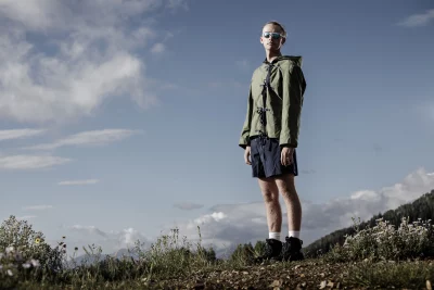 A model stands on a grassy hill wearing Brennah's Intrepid collection.