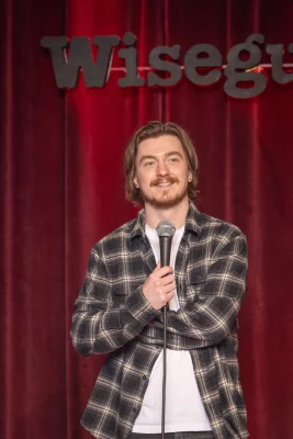 Tre Lamb holds a microphone onstage at Wiseguys.
