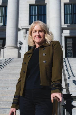 Portrait of UFC Director Virginia Pearce standing on a staircase.