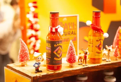 Two bottles of Flaming Homer's hot sauce on display.