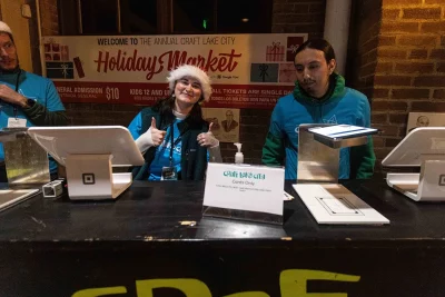 Jamie Christenson, SLUG Magazine’s Junior Editor, welcomes crowds to the holiday market.