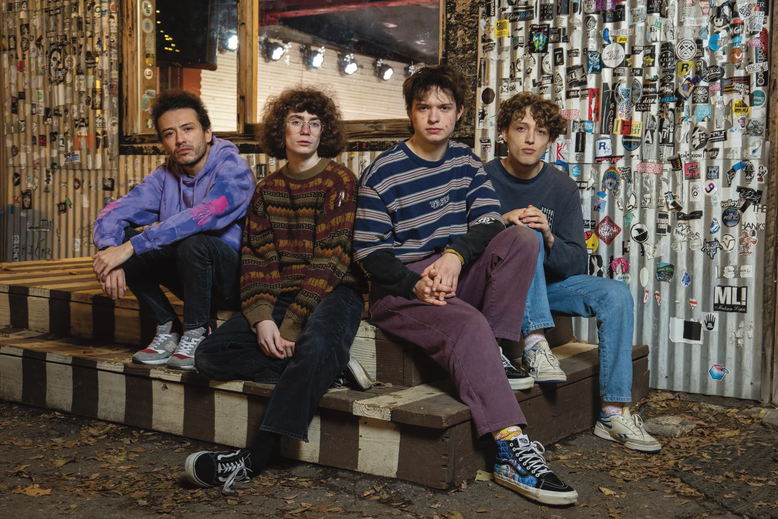 The members of Air Vent Dweller—Mikey Sandoval, Snoopy Herron, Charlie Pell and Alex Sandoval—sit on the steps outside Kilby Court.