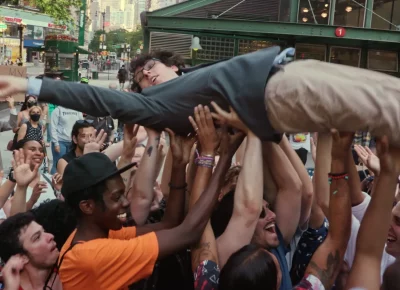 A man crowdsurfing in Citizen Weiner.