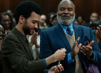 People stand around clapping.