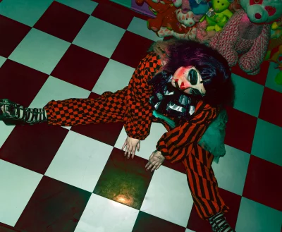 Shortcake stares up at the camera, sitting in the splits. 