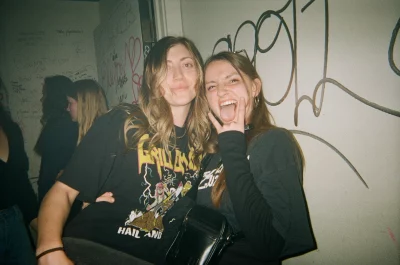 A few girls posed together in the bathroom of a bar.