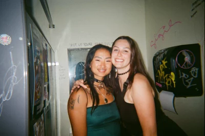 A few girls posed together in the bathroom of a bar.