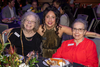 Three women posing for a photo together.