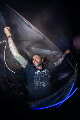 A long exposure shot of Chris LaPointe holding up his microphone. 