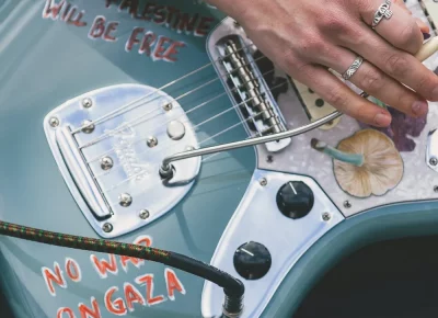 A closeup of a guitar during Daytime Lover's set.
