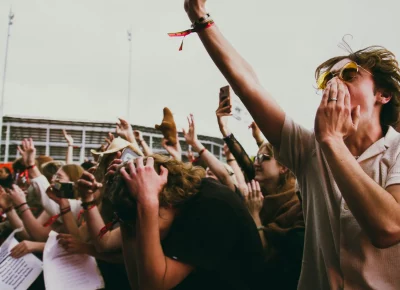 The crowd at Kilby Block Party throws their hands up.