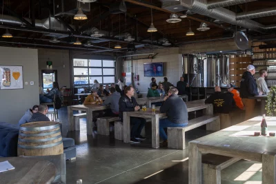 Patrons at tables in a taproom.