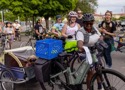 This cargo-bike copilot in shades kept Priya company on the SLUG Cat. Photo: TaCara DeTevis.