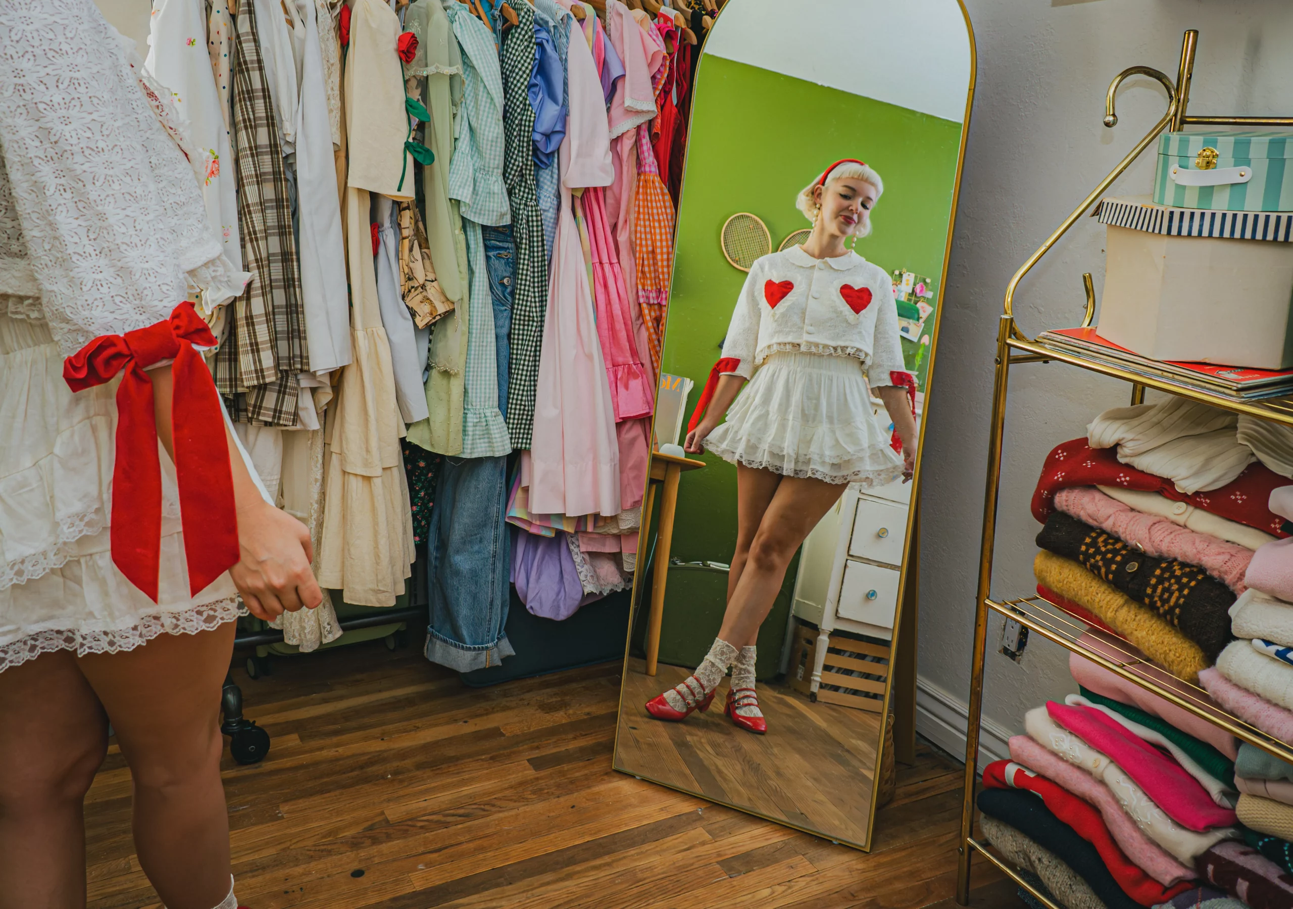 Zander stands in front of a golden mirror in her dressing room. She does a little curtsey to the camera.