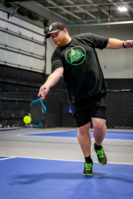 Nick Bolton hits a ball with his paddle.