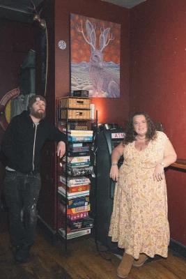 Mike Brown and Sunyin Marci stand in The Jackalope Lounge. 